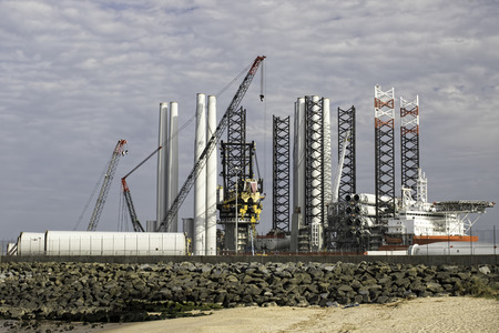 Port supplying turbine parts for offshore wind farm construction. Green renewable energy investment at the Great Yarmouth outer harbour Norfolk, UK.の写真素材