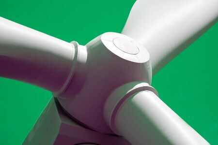 Green energy. Close up of wind turbine against green background. Sustainable renewable energy.の写真素材