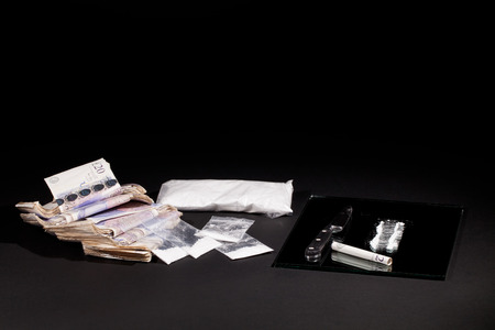 Drug dealing. Cocaine drugs haul with UK money and a line of coke. Bags of cocaine and heroin.
