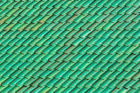 Green roof tiles. Patterned and textured background image of vibrant colored tiles forming a geometric pattern.の写真素材
