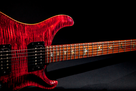 Quality electric guitar. Luxury expensive guitar with red flame maple carved top and bird inlays...