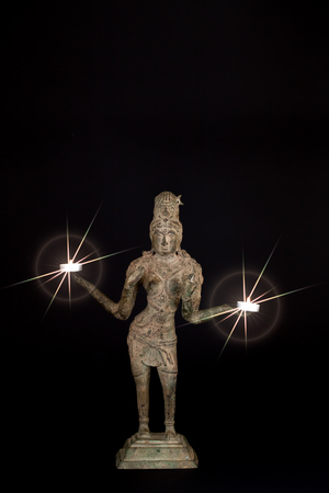 Spiritual enlightenment. Hindu Goddess Lakshmi with divine light from candles. Diwali festival of lights.の写真素材