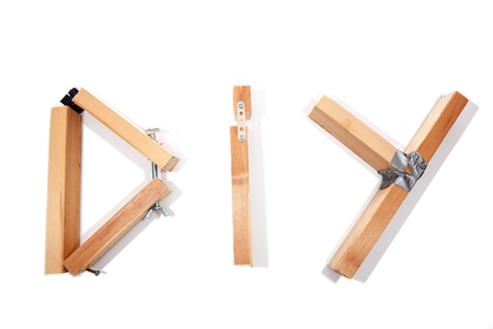 D.I.Y. disaster. Badly constructed wooden D I Y sign letters representing bad do it yourself. White background with copy space.の写真素材