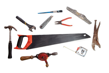 Old tool shed tools. Vintage pliers, wood saw, hand drill and hammer etc. Handyman toolbox tools...