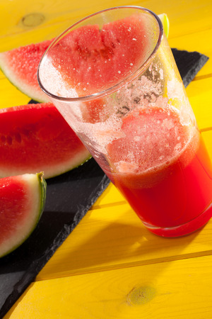 Summer fruit juice drink. Cool refreshing watermelon smoothie. Hot day refreshment. Vibrant colorful image.の写真素材
