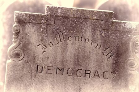 In Memory of democracy. Brexit referendum and election concept image. Gravestone with the word democracy. Political madness and modern politics gone bad.の写真素材