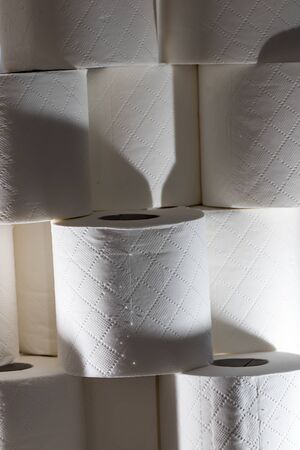 Sinister generic toilet roll background image. Coronavirus Covid-19 hoarding. Stack of loo rolls....