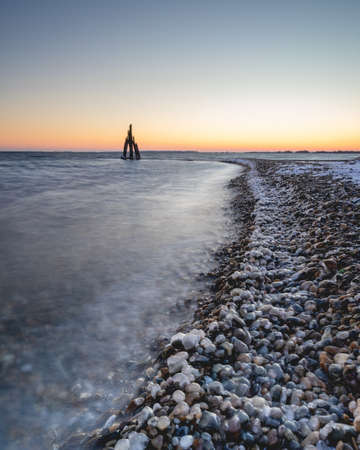 Ice cold morning on the coast in Den Osse Zeeland, The Netherlandsの写真素材