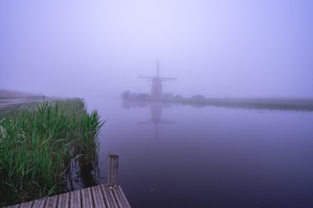 Foggy morning at the windmills at Kinderdijk, The Netherlands.のeditorial素材