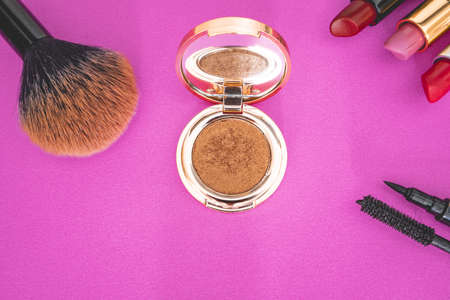 Flat lay of make up and beauty products on a pink background.の写真素材