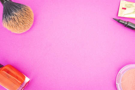 Flat lay of make up and beauty products on a pink background.の写真素材