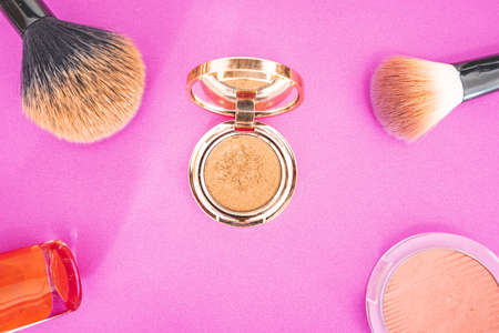 Flat lay of make up and beauty products on a pink background.の写真素材