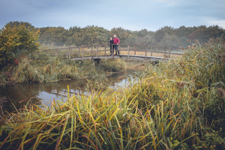Couple standing on the bridge, Early morning autumn at Delft, The Netherlands. Oct 21 2022.の写真素材