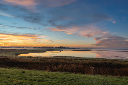 Beautiful sunrise over the dutch countryside. Den Osse, Zeeland, The Netherlands.の写真素材