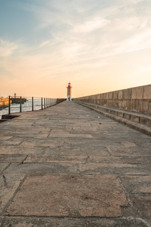 Farolim de Felgueiras, Pier and lighthouse at Porto, Portugal During sunset.の写真素材