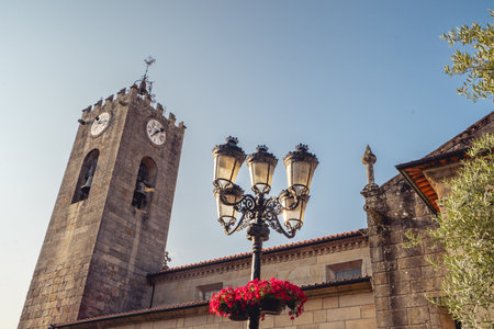 Old church and streetlight, in the Center of Ponte de Lima, Portugal.