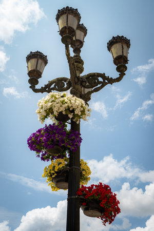 Old streetlight decorated with flowers at Ponte de Lima, Portugal.の写真素材