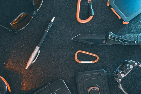 Top view of accessories for mountaineering on black background with copy space