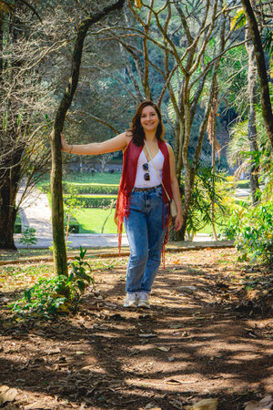 Brazilian Woman in a red sweater posing, when she takes a walk in the Jardim Botanic Garden, In SÃ£o Paulo, Brazil.の写真素材