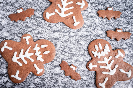 Halloween chocolate cookies, shaped and decorated in a Halloween theme. On a gray background.