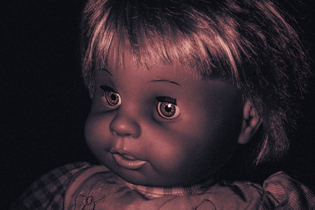 Creepy doll on a dark background. Halloween background.の写真素材