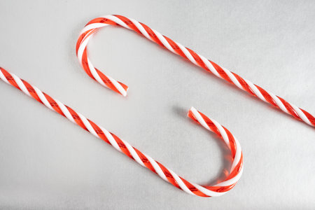 Christmas candy canes laying down on a gray background. Christmas Background.の写真素材