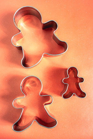 shape for Christmas cookies or ginger bread, on a red background.の写真素材
