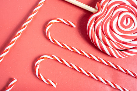 Christmas candy cane, and lollipop swirls. On a red background.の写真素材