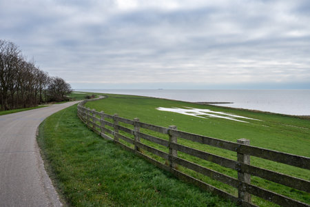 Typical Dutch landscape, with a dyke and the sea.の写真素材