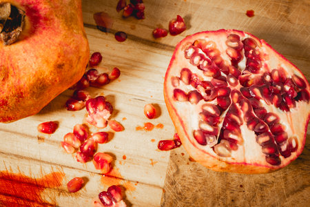Pomegranates cut in half on a wooden background.の写真素材