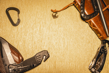 Black and leather EDC gear on a beige background.の写真素材