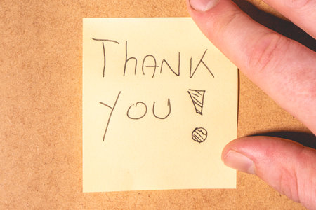 A Thank you note on a brown background.の写真素材