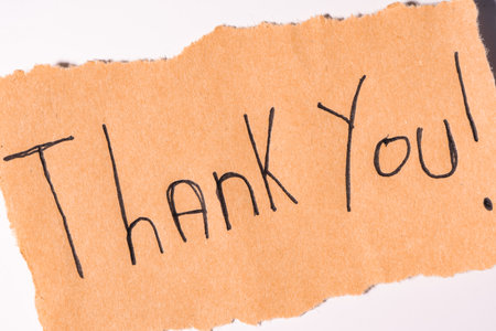 A Thank you note on brown paper, on a white backgroundの写真素材