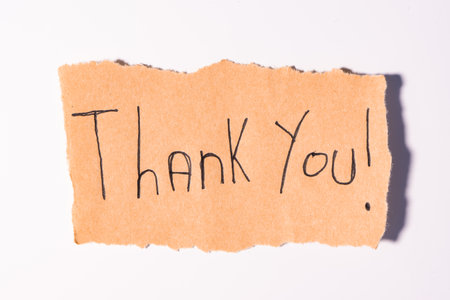 A Thank you note on brown paper, on a white backgroundの写真素材