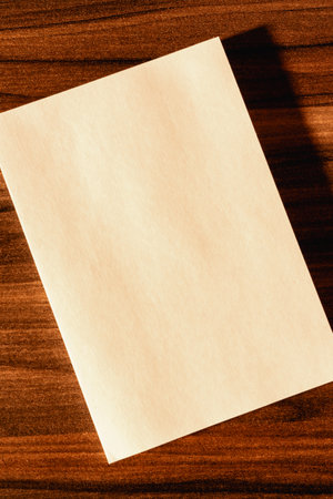 An empty piece of paper on a wooden table.