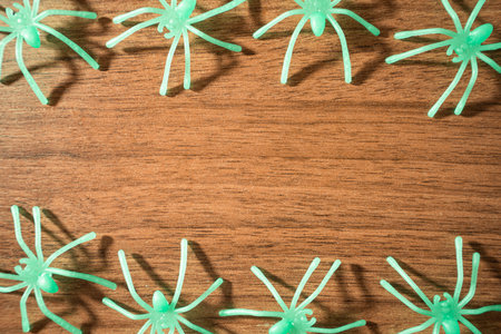 Fake spiders on a wooden background. Halloween background.