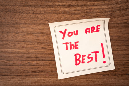 Sticky notes with a positive message, on a wooden background. Creative background.の写真素材