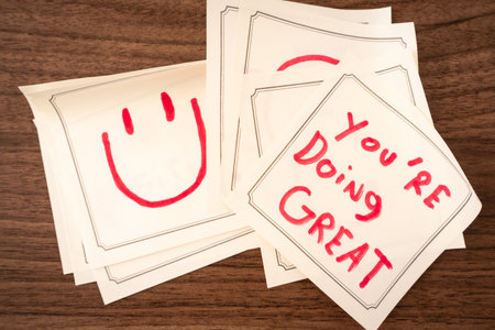 Sticky notes with a positive message, on a wooden background. Creative background.