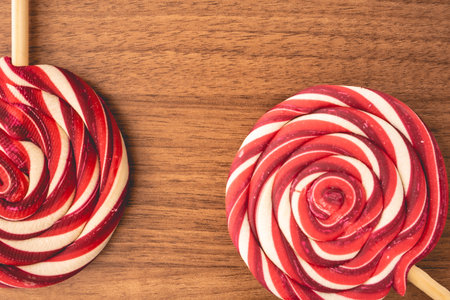 Christmas lollipops with red and white swirls, on a wooden background. Christmas background.の写真素材