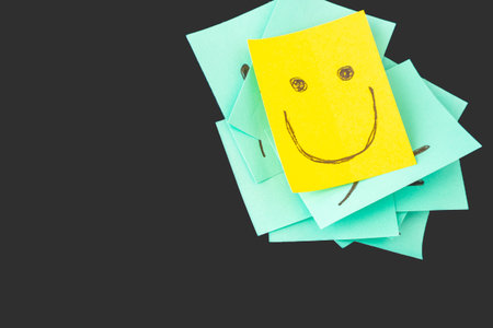 Sticky notes with smileys. On a dark gray background.の写真素材