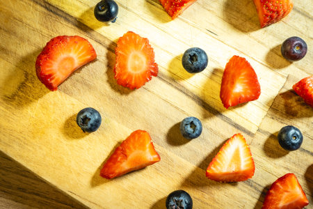 Strawberries and blueberries on a wooden cutting board. Healthy food.