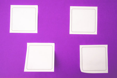 Empty sticky notes, on a purple background.の写真素材