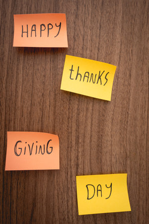 Happy Thanksgiving day, written on a sticky note. On a wooden background.の写真素材