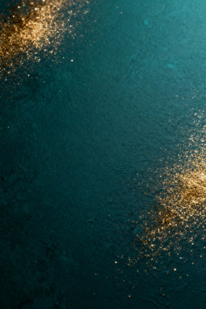 AI generated images. A structured dark blue/green background, with golden glitter and light. Background for Christmas or New Year.の素材