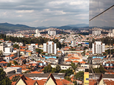 Skyline of the North part of Sao Paulo, with a reflection of. a glass building. Tucuruvi, Sao Paulo, Brazil. November 25, 2025.のeditorial素材