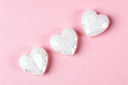 White cristal shaped hearts, on a soft pink background. Valentin's Day. AI generated.の素材