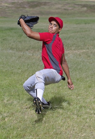 Baseball player winds up for a big pitchの写真素材