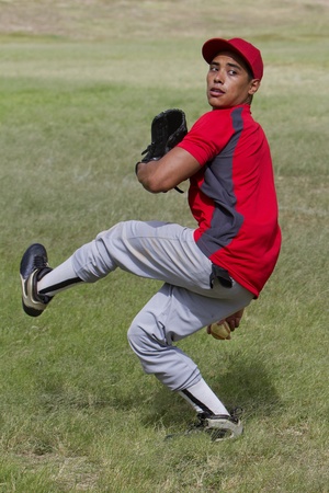 Baseball player mid-pitchの写真素材