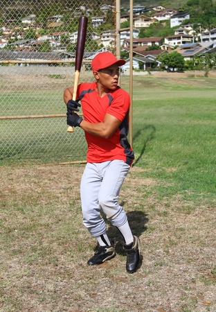 Baseball player stands at bat, ready to swingの写真素材