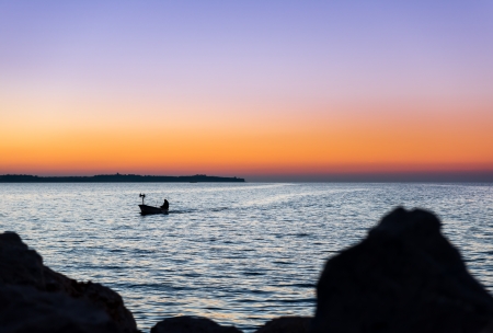 Fisherman coming home  Small boat returns home after evening fishing  Winter noon の写真素材